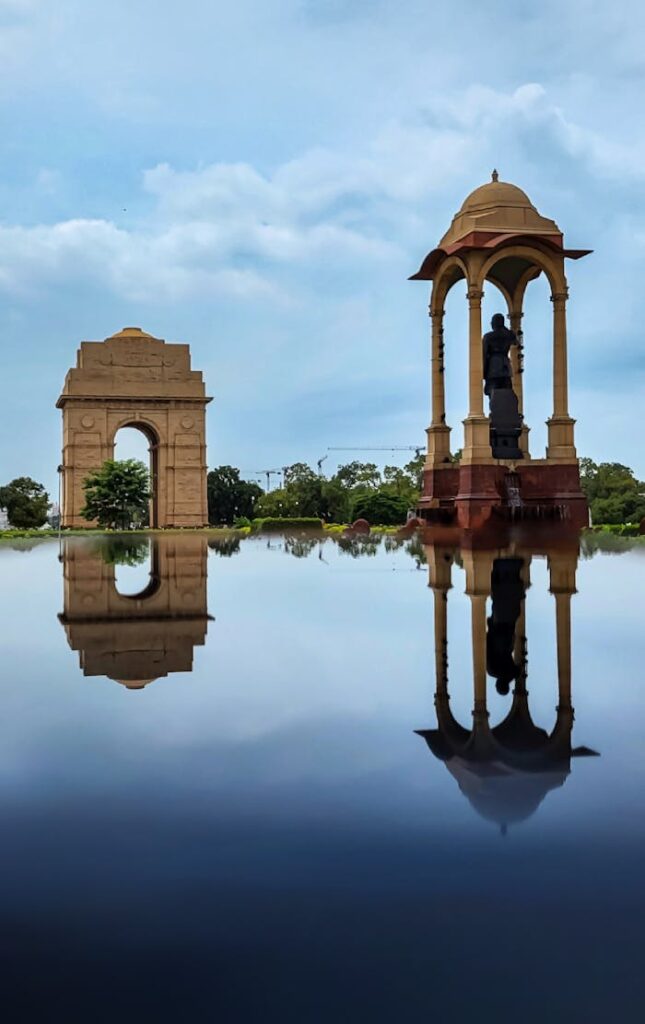 delhi local sightseeing Scenic view of the India Gate and canopy reflection in water, New Delhi, India.