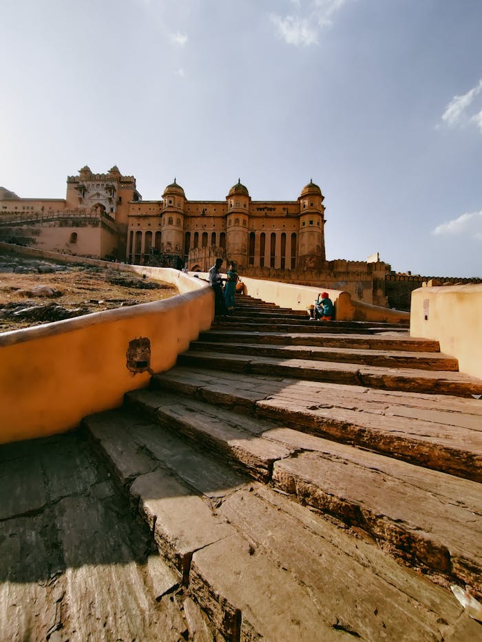 Explore the iconic Amer Fort in Jaipur with its historic architectural beauty and sunlit stone steps.