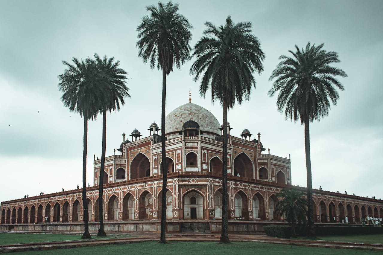 portfolio-img-04 Low angle of beautiful well maintained garden with palms and ancient building of Humayun s Tomb located in Delhi