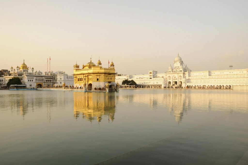 pexels photo 5035710 5035710 Golden Temple in Amritsar, India, beautifully reflecting in the water during sunset.